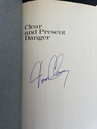 Clear and Present Danger [SIGNED; TOGETHER WITH ORIGINAL SIGNED CORRESPONDENCE FROM TOM CLANCY TO THE WIDOW OF JOHN BALL TO WHOM THIS BOOK WAS DEDICATED]